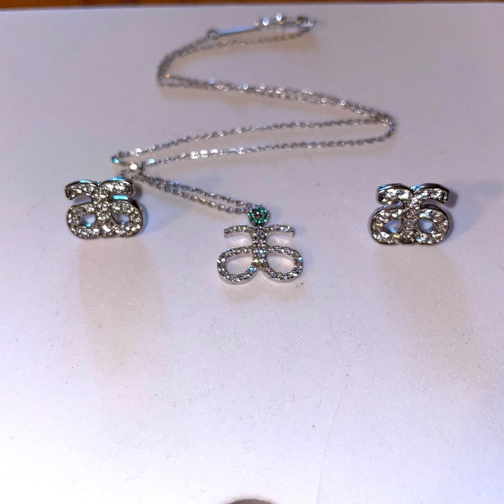 Arbonne logo matching earring and necklace set.
